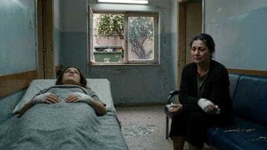 A dimly lit, narrow medical clinic room rendered in muted, desaturated tones of grey and pale blue. In the foreground, a young woman lies on a worn clinic bed, her eyes fixed on the ceiling, her bandaged hands resting motionless on a thin blanket. Beside her, an older woman sits hunched on a shabby sofa, her face pale and hollow-eyed, her own bandaged hands resting in her lap, tears streaming silently down her weathered cheeks. Between them on the floor, scattered shards of broken glass catch the weak fluorescent light. Through a small grimy window in the background, barely visible outside, a large overflowing garbage dumpster sits beneath a jasmine tree, its white blossoms falling softly. The atmosphere is heavy with grief, disconnection, and unspoken generational pain. Cinematic, literary realism style with dramatic chiaroscuro lighting, evoking isolation and emotional devastation.